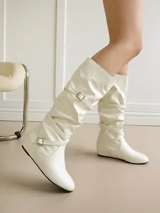 Chic cream slouchy mid-calf boots with buckle straps and pleated leather texture