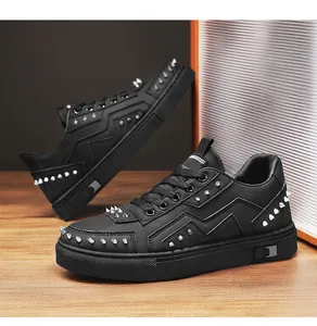 Detailed view of black men's sneakers featuring silver studs and zigzag leather panels