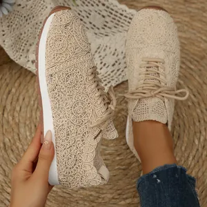 Detailed view of beige lace mesh sneakers featuring intricate floral patterns and white soles