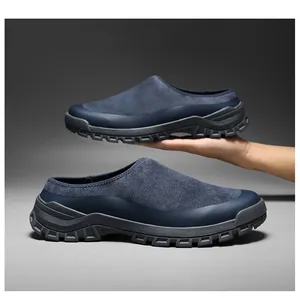 Detailed view of navy blue suede slip-on clogs with rugged anti-slip soles