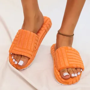 Bright orange thick-soled terry cloth slides with embossed pattern for women indoor use