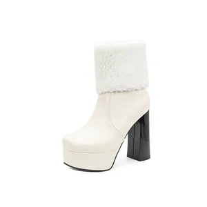 Side view of cream platform ankle boot with faux fur cuff and black block heel