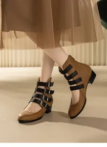 Vintage brown Mary Jane ankle boots with four black buckle straps and low thick heels.