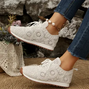 2026 New stylish women's white crochet lace mesh sneakers with floral patterns on model