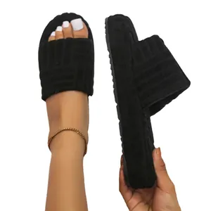 Stylish cozy black platform fuzzy slippers with textured embossed pattern for women