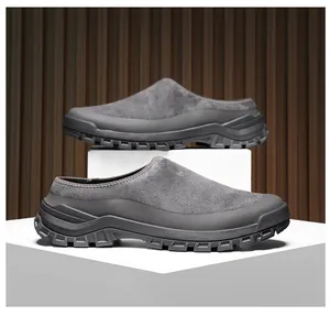 Close-up of men's suede closed-toe clogs with thick durable rubber soles on plinths