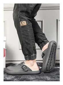 Detail of men's grey fleece-lined winter clogs with stylish buckle and non-slip sole