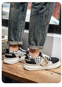 Detail of men's breathable woven sneakers with thick soles and houndstooth pattern