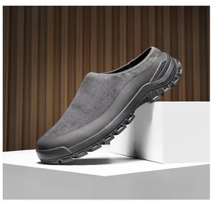 Detailed side view of a grey suede slip-on shoe resting on white minimalist geometric blocks
