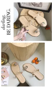 Top view detail of stylish beige flat sandals featuring pearl straps and pineapple charms