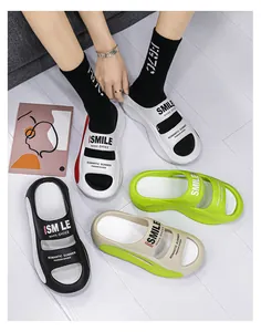 Various colors of thick-sole EVA summer slippers featuring trendy 'SMILE' printed patterns