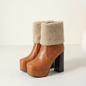Side view of brown platform ankle boots with fuzzy beige fleece trim and chunky heels
