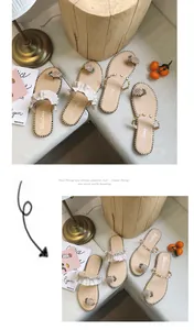Detail view of women's flat sandals with pineapple toe rings and ruffled straps.