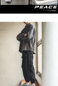 Fashionable man wearing a grey shirt and black cargo pants with trendy outdoor sports shoes