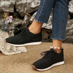 Elegant black lace patterned women's sneakers featuring a classic lace-up design