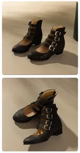 Close-up of black Roman-style Mary Jane boots with multiple buckle straps and block heel