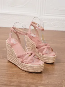 Side view of pink suede espadrille wedge sandals with platform straw sole detail