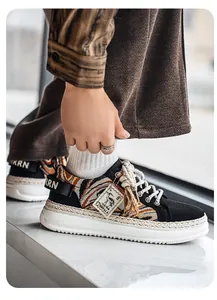 Close-up detail of men's thick-sole sneakers featuring ethnic woven pattern and rope trim