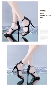 Side view of black high-heeled sandals with glittery heart straps and stiletto heels