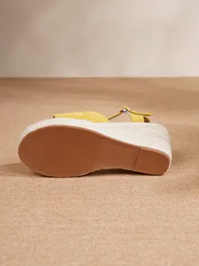 Close-up detail of the non-slip sole for women's yellow espadrille wedge sandals size 37