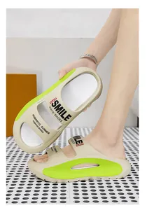 Detailed view of stylish EVA beach slides with thick sole and vibrant green accents