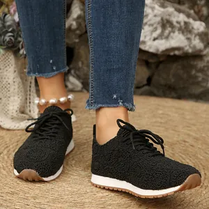 Womens black crochet mesh lace-up sneakers featuring white midsole and gum rubber sole