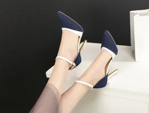 Close-up of stylish denim pointed-toe stiletto heels with elegant white ankle straps