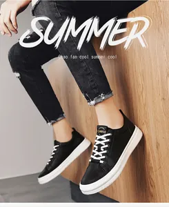 Black leather low-top casual sneakers with white soles worn with black jeans