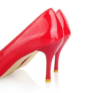 Gros plan d'élégants talons aiguilles en cuir verni rouge au fini brillant