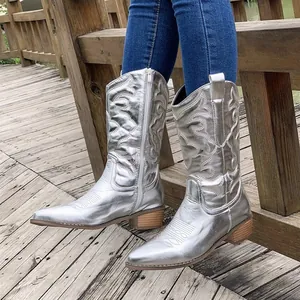 Side view detail of silver metallic mid-calf cowboy boots with chunky low heels