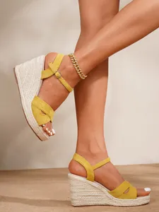 Stylish yellow suede espadrille wedge sandals with straw platform and ankle strap