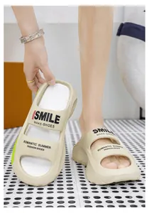 Detailed view of beige platform EVA slides with "SMILE" printed design elements.