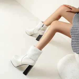 Elegant white platform ankle boots with plush fur trim and chunky high heels on model