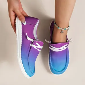 Close-up of women's purple and blue gradient canvas loafers with white laces