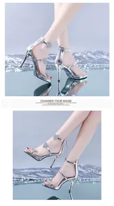 Close-up of silver high heel sandals with rhinestone heart straps and platform sole.