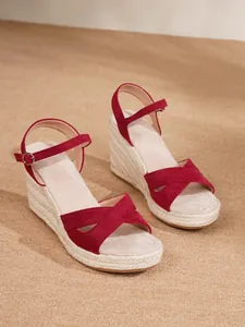 Detailed side view of red espadrille wedge sandals with ankle strap and jute sole