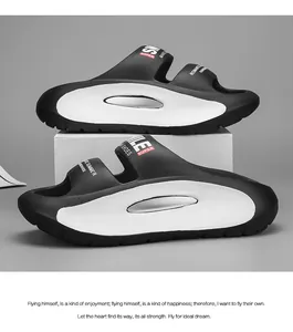 Detailed side view of stylish black and white EVA sports slides with thick soles.