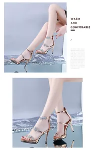 Detailed view of gold stiletto sandals with rhinestone star accents and platform.
