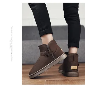 Detailed view of brown suede snow boots with metal buckle and warm winter lining