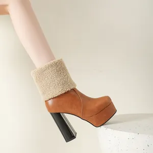 Close-up of brown platform ankle boot featuring a fluffy sheepskin cuff and high block heel