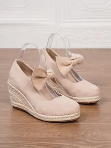 Espardeñas de cuña de ante nude con detalle de lazo y plataforma de cuerda trenzada
