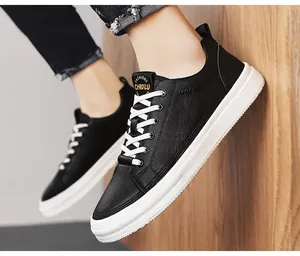 Detailed view of premium black leather low-top sneakers featuring white contrast soles