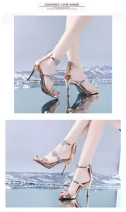 Detailed view of gold stiletto sandals featuring crystal heart accents and platform.
