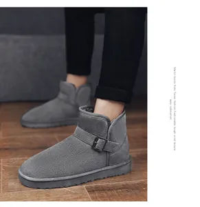Close-up detail of gray suede snow boots with buckle strap and warm fleece lining