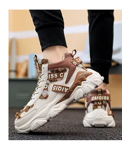 Close-up of men's high-top chunky sneakers with frayed fabric and brown strap details