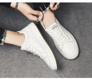 Stylish white leather low-top sneakers for men shown on foot in a street style setting