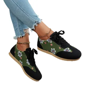 Stylish women's floral print canvas sneakers featuring green and black panels with lace-up design