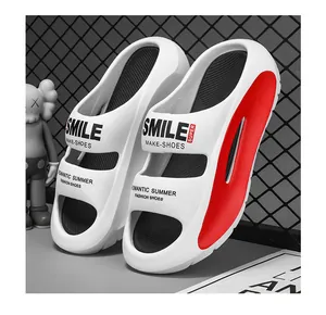 Detailed view of comfortable white summer EVA slides with red accents and printed smile text