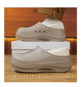 Side view of khaki fleece-lined winter clogs with thick sole and warm white lining