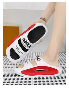 Close-up detail of soft EVA thick sole and printed straps on red and white beach slippers